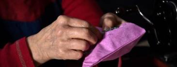 Hands darning a cushion