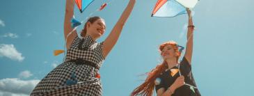 Young women holding kites